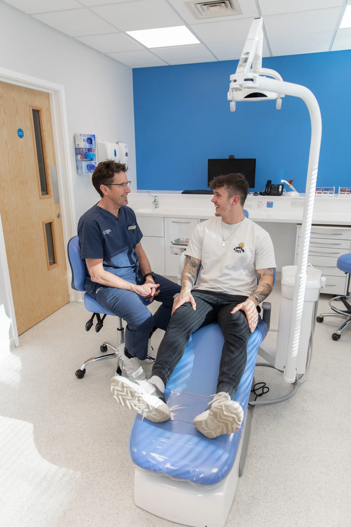patient sat in chair with dentist